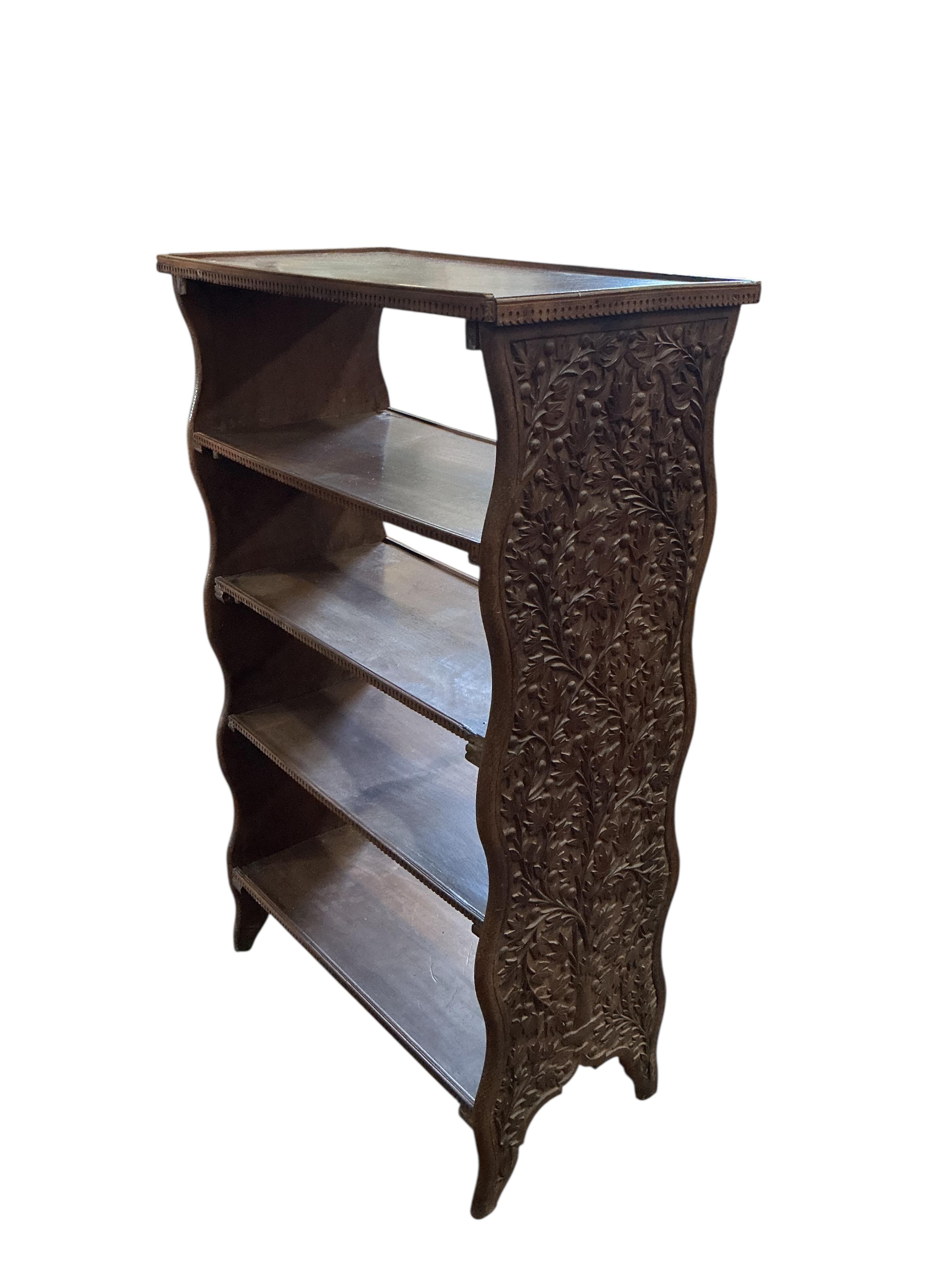 An Indian hardwood open bookcase, width 66cm, depth 34cm, height 107cm